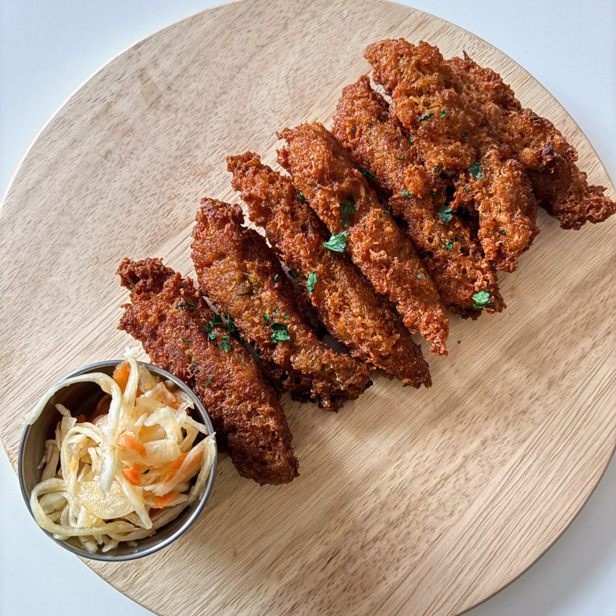 Haitian Akra with Piklez on a wooden serving platter