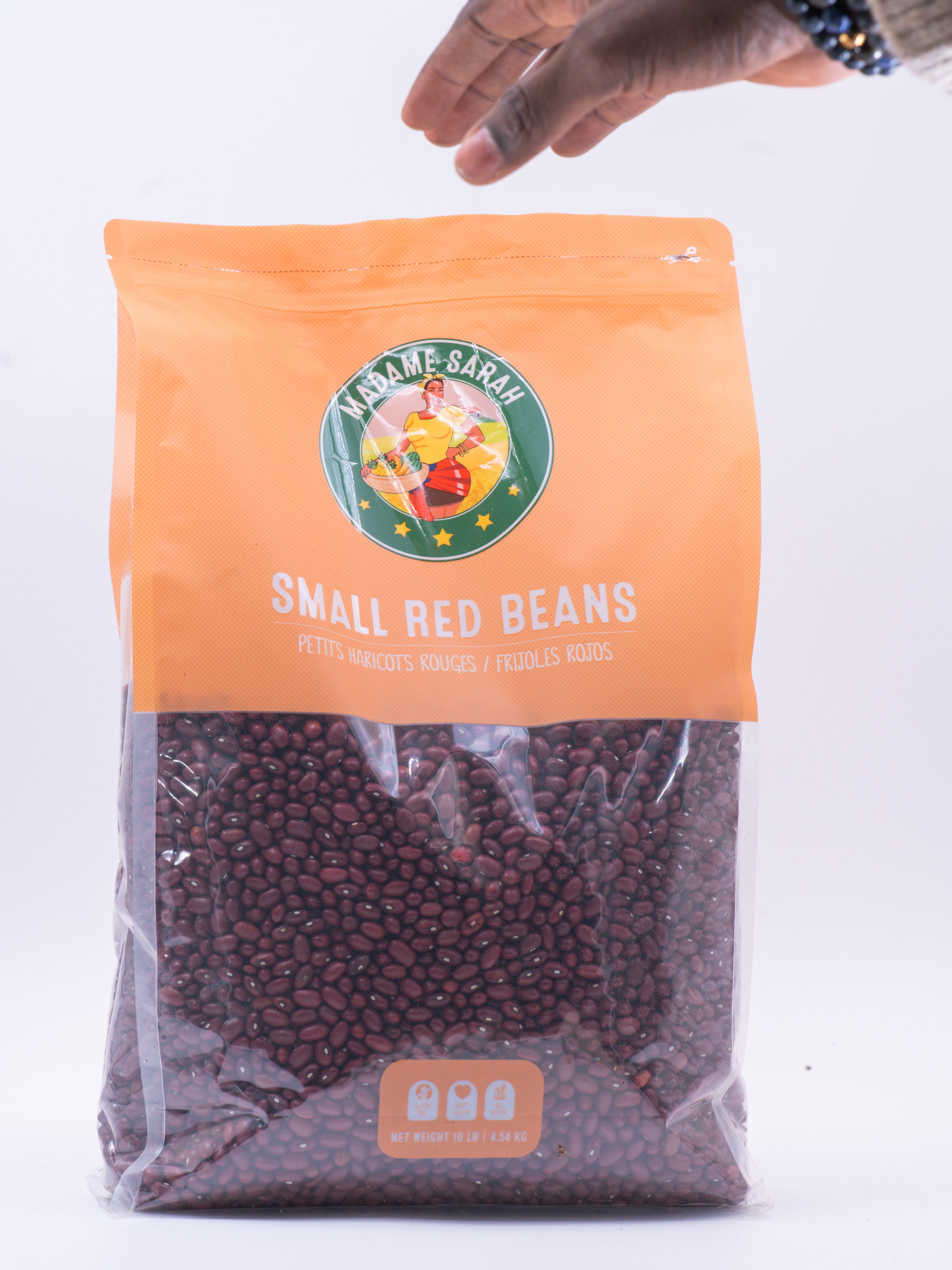 Hand reaching for package of Madame Sarah Small Red Beans